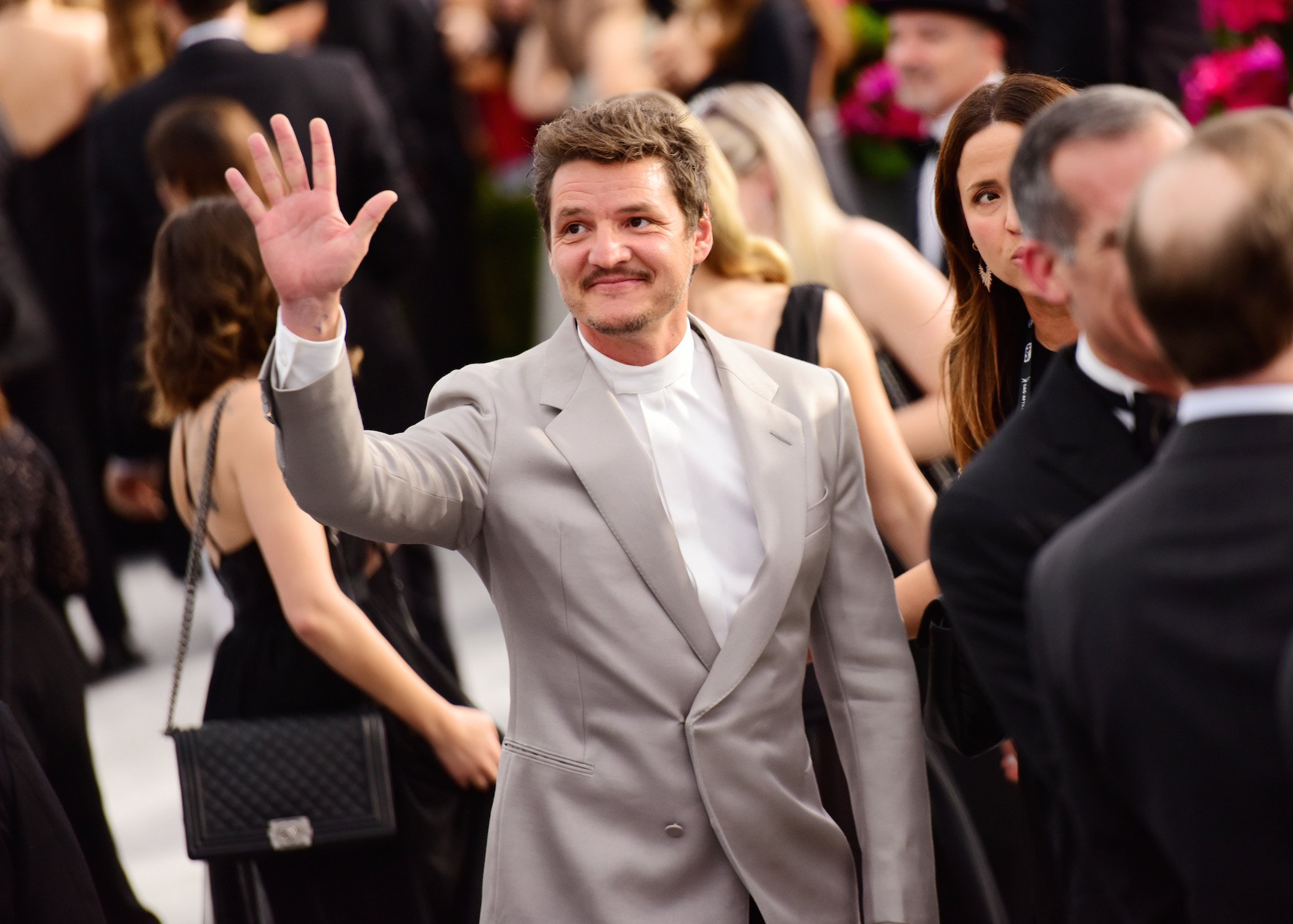 Pedro Pascal waving in a crowd