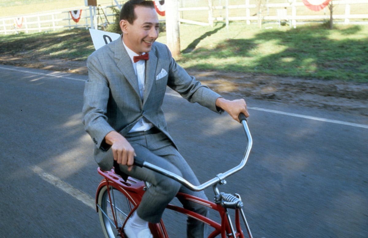 Paul Reubens rides a bike in a scene from the film 'Pee-Wee's Big Adventure'