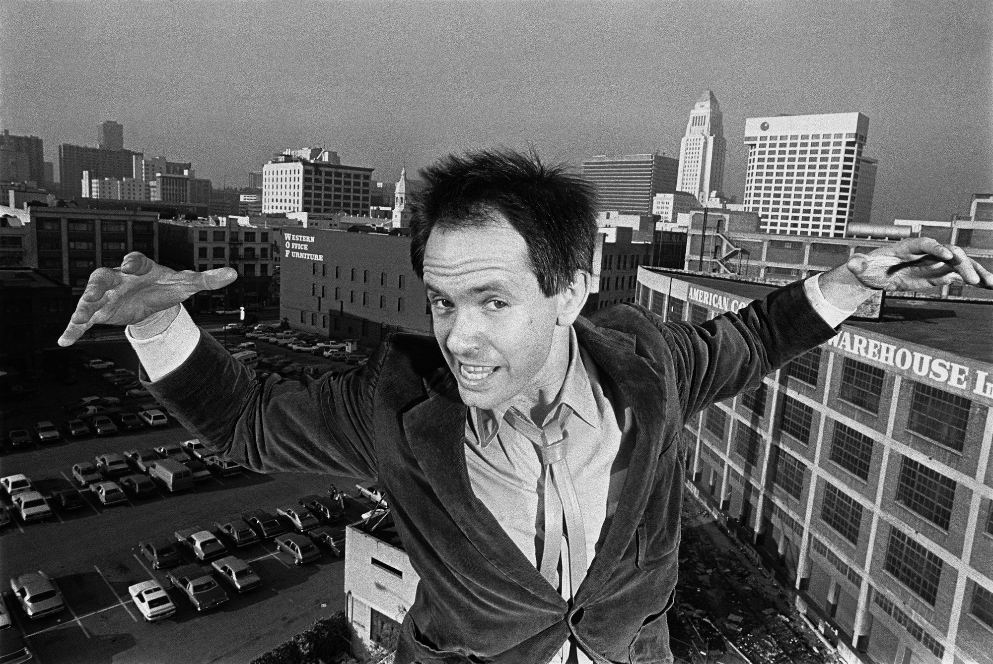 Peter Ivers playfully poses on the roof of his apartment