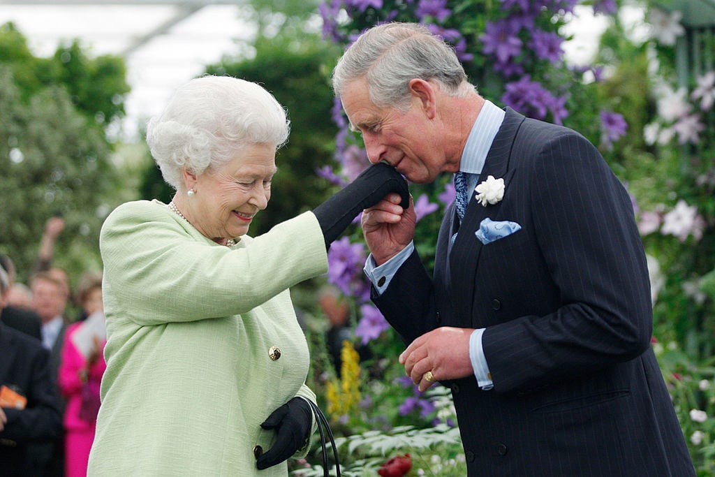 Prince Charles air kissing Queen Elizabeth's hand
