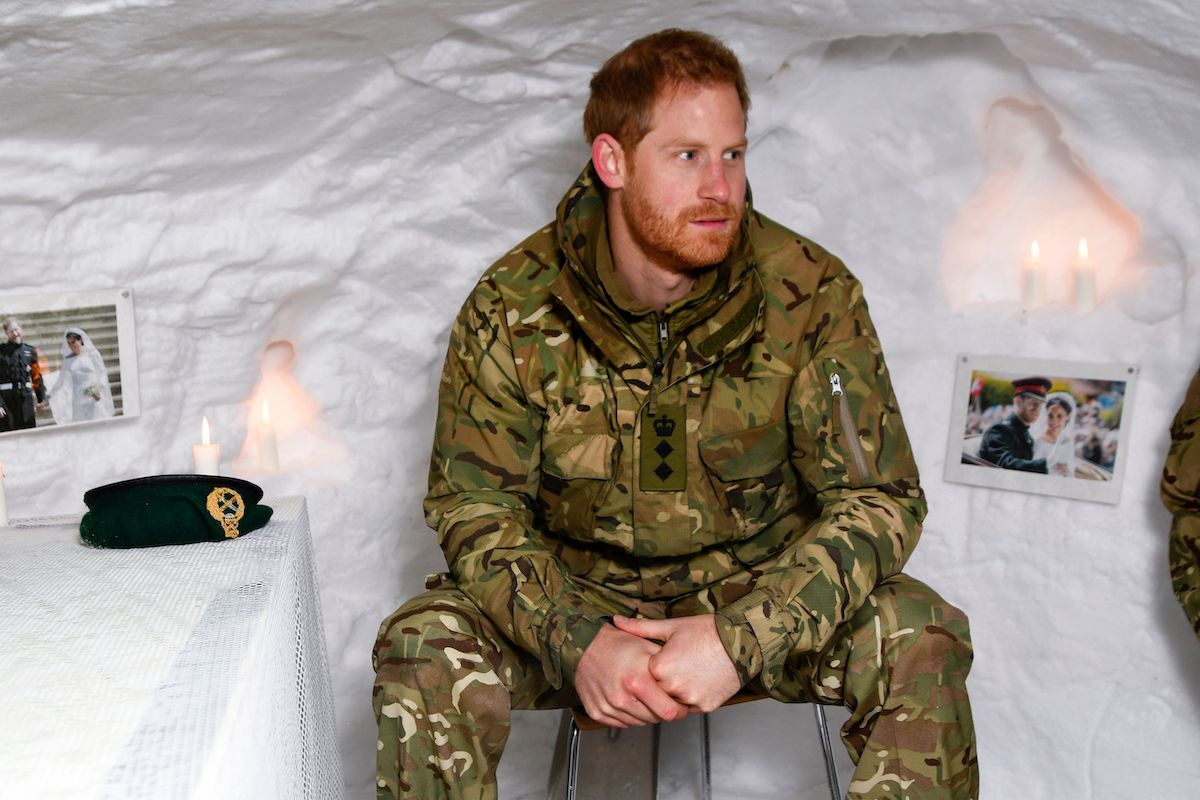 Britain's Prince Harry, Duke of Sussex, sits in a snow cave made by British military personnel