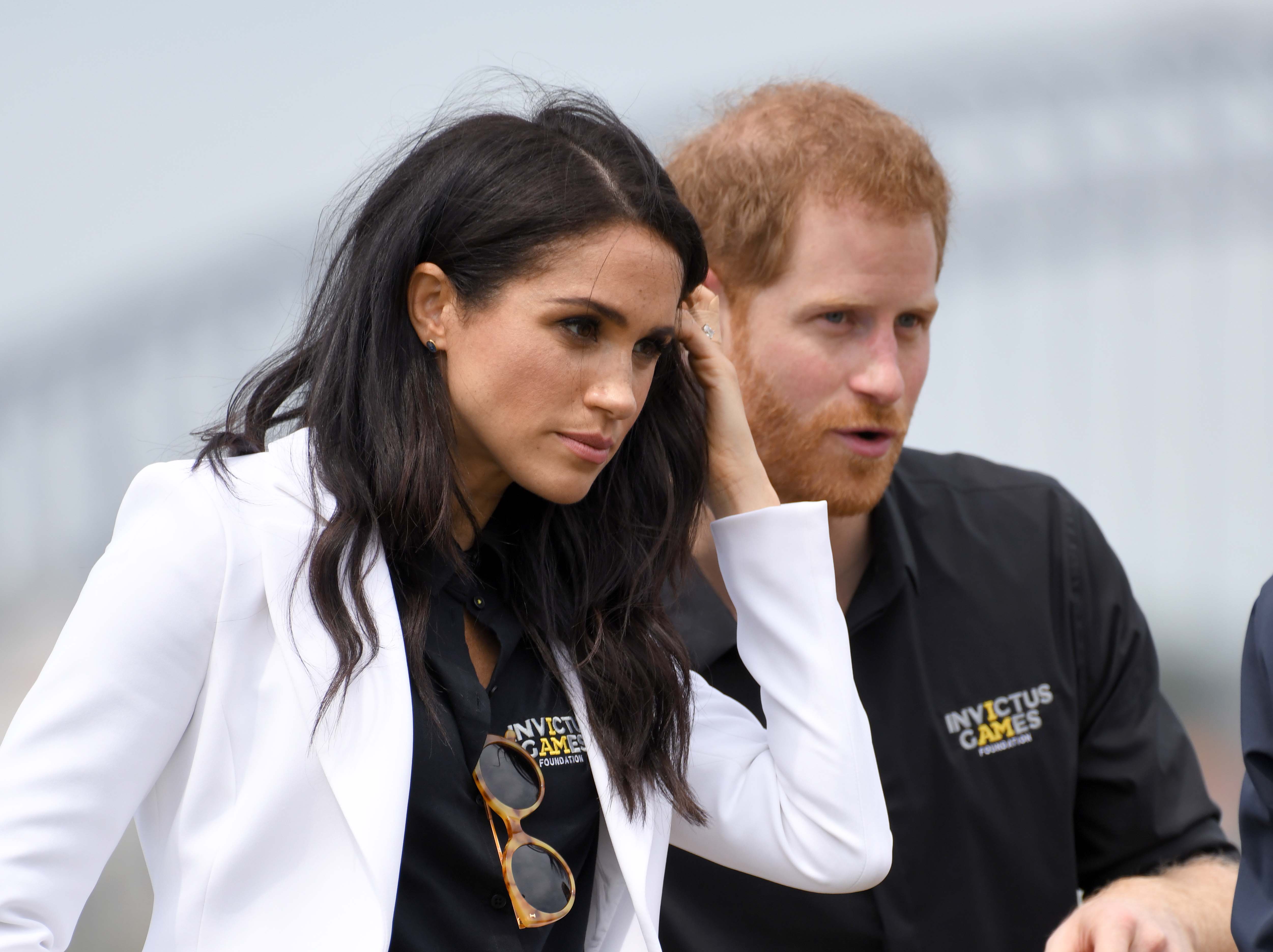 Prince Harry and Meghan Markle stand together at Invictus Games in Sydney, Australia
