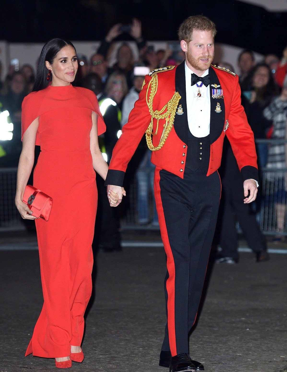 Prince Harry and Meghan Markle hold hands as they arrive at the Mountbatten Festival of Music