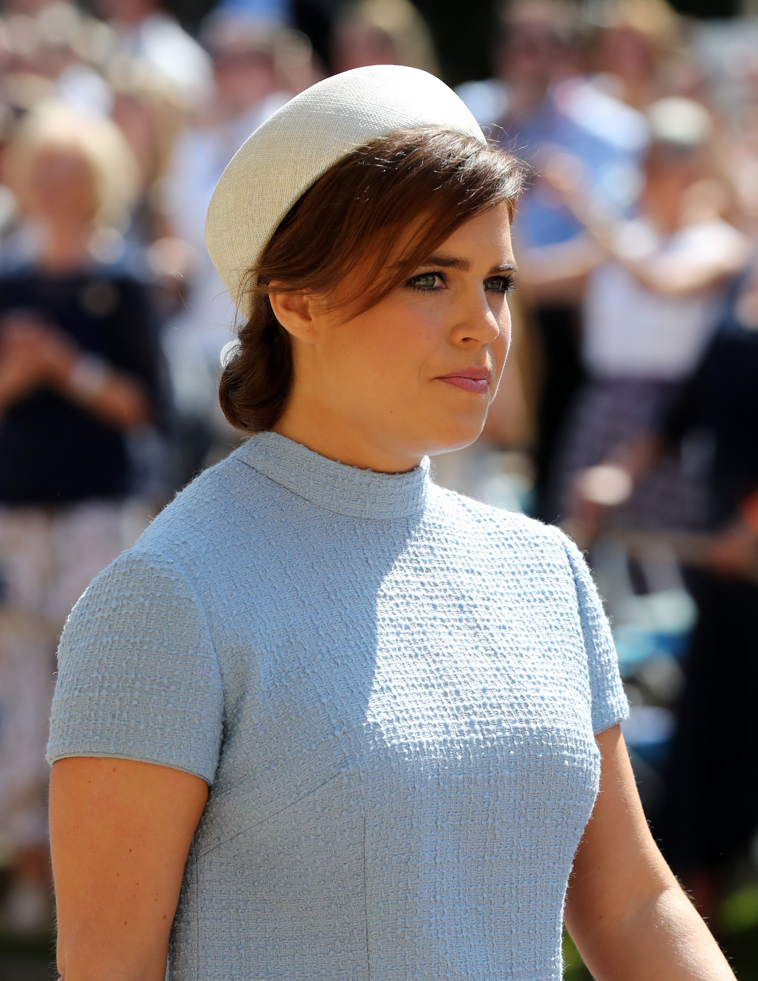 Princess Eugenie arriving to Harry and Meghan's wedding in a pale blue dress and cream fascinator