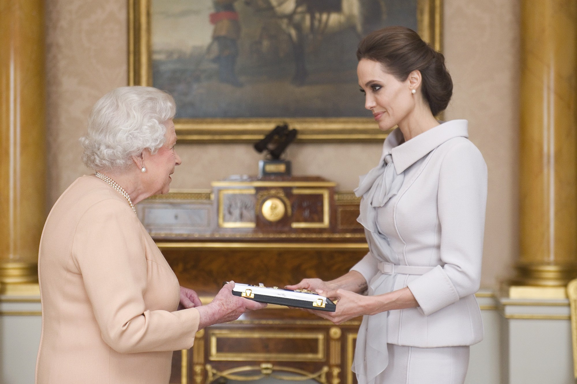(L-R) Queen Elizabeth II and Angelina Jolie, exchanging a framed award