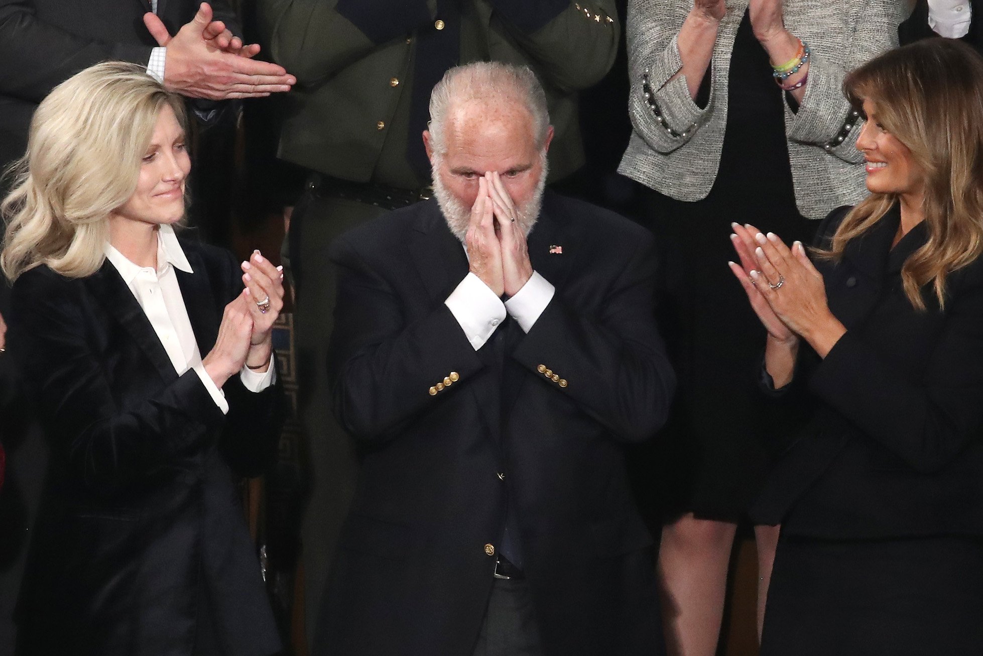 Rush Limbaugh looking surprised next to Kathryn Adams Limbaugh and Melania Trump