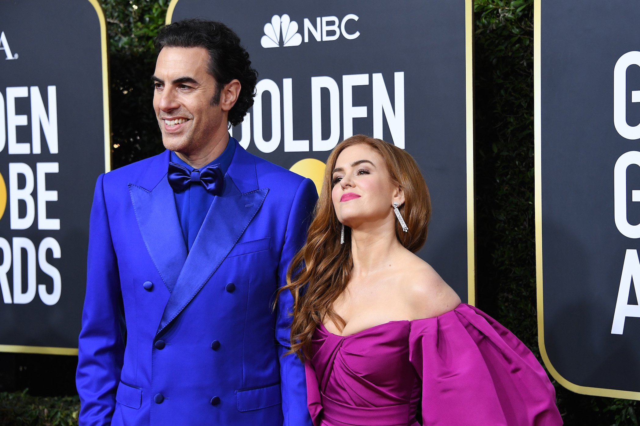 Sacha Baron Cohen standing next to his wife, Isla Fisher, at the Golden Globes