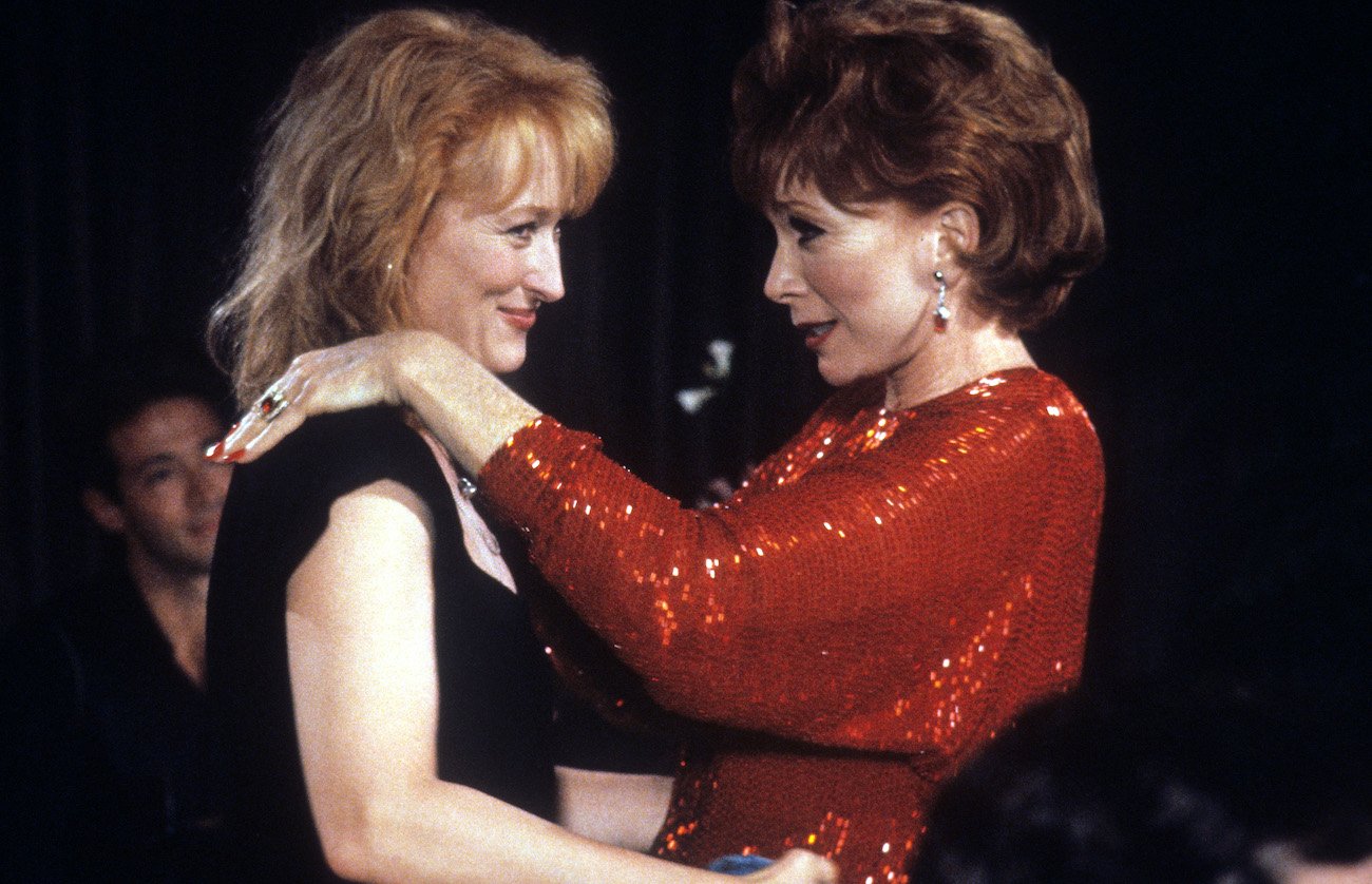 Meryl Streep holds Shirley MacLaine in a scene from the film 'Postcards From The Edge', 1990