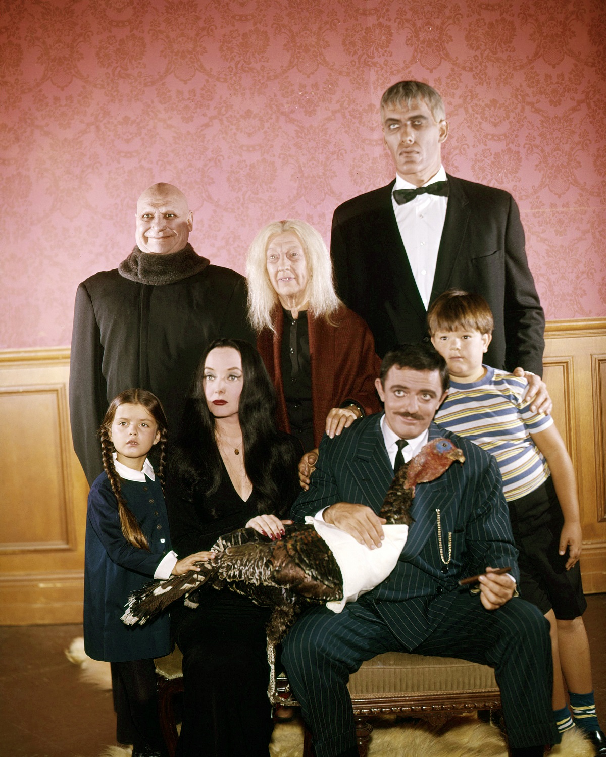 Jackie Coogan as Uncle Fester, Blossom Rock as Grandmama Addams, Ted Cassidy as Lurch. Lisa Loring as Wednesday Addams, Carolyn Jones as Morticia Addams, John Astin as Gomez Addams, and Ken Weatherwax as Pugsley Addams in a promotional photo for 'The Addams Family'