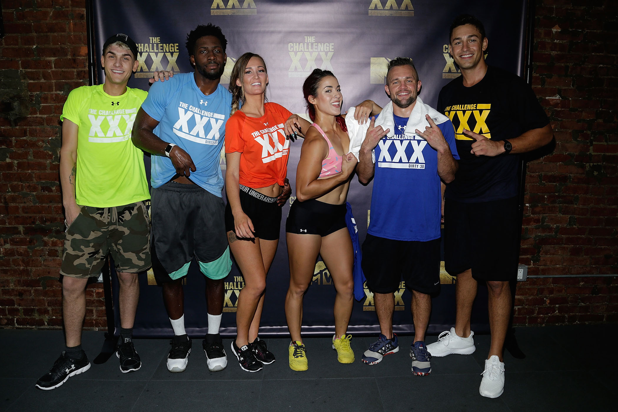 Cast members from MTV's 'The Challenge' standing together and posing for a photo