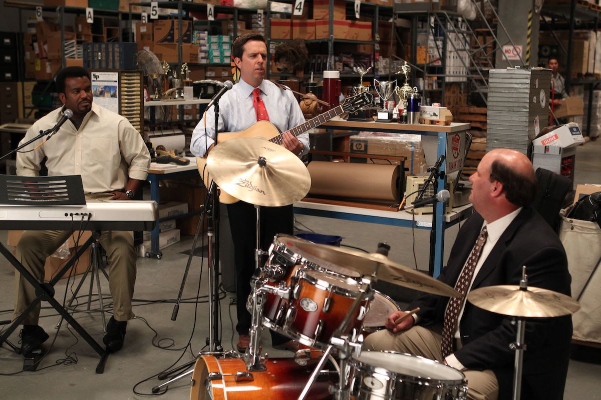 Craig Robinson as Darryl Philbin is playing keyboard, Ed Helms as Andy Bernard is playing guitar, Brian Baumgartner as Kevin Malone is playing drums on 'The Office'