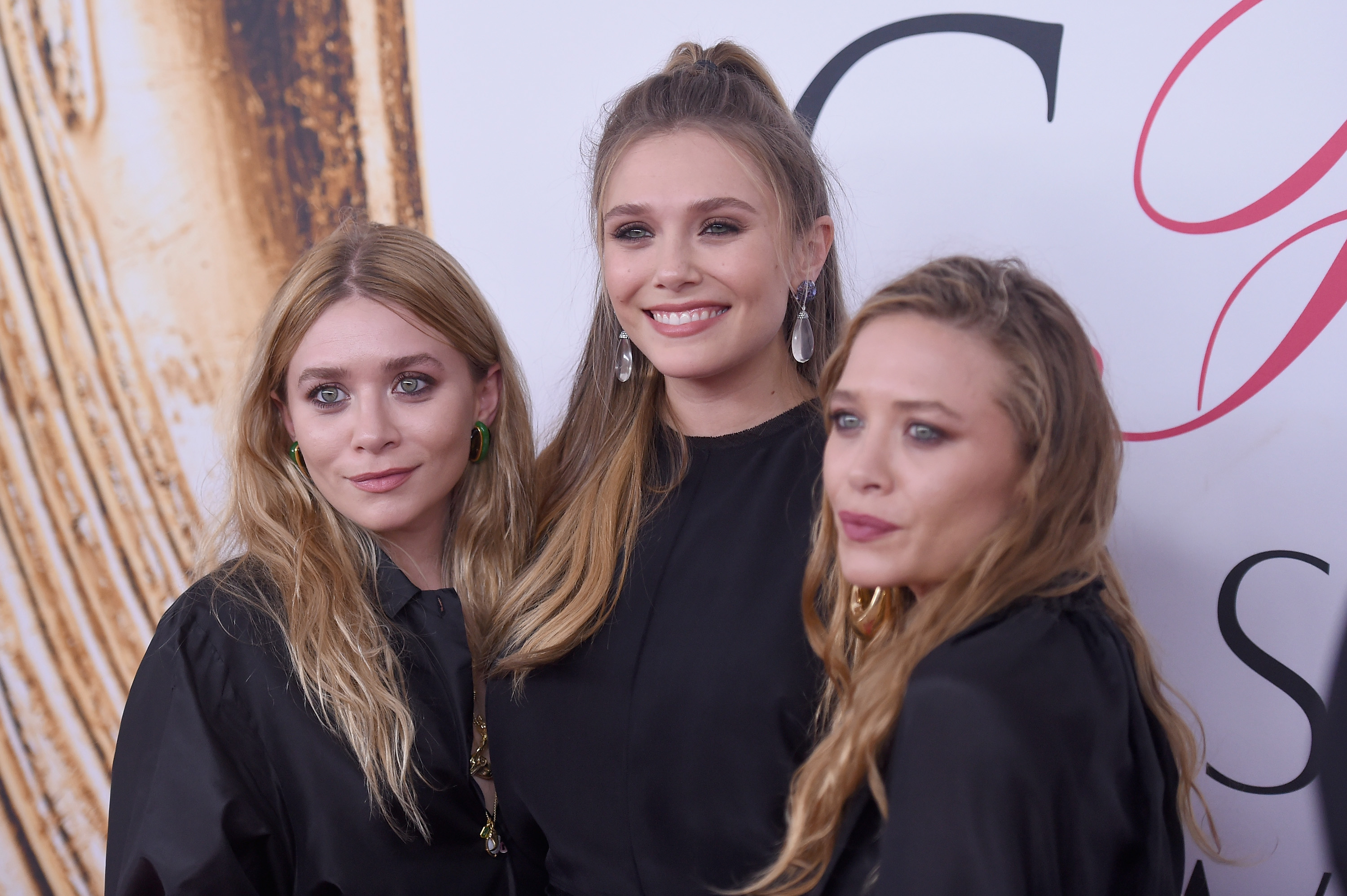 Elizabeth Olsen (center) with Mary-Kate and Ashley Olsen appear at the 2016 CFDA Fashion Awards at the Hammerstein Ballroom