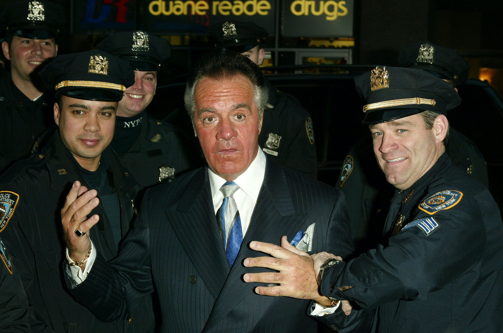 Actor Tony Sirrico posing with NYPD officers