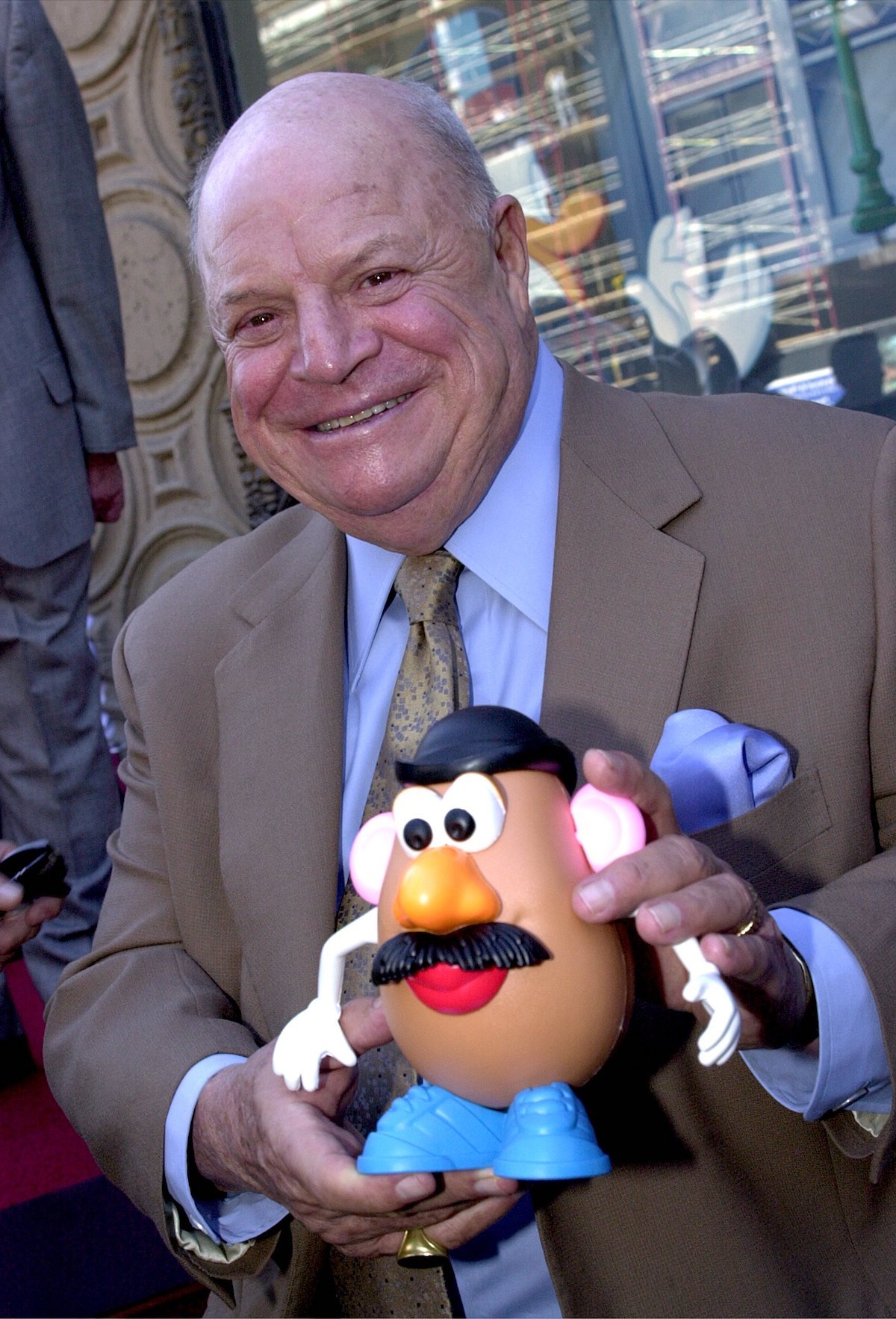 Don Rickles holds a "Mr. Potato Head" doll