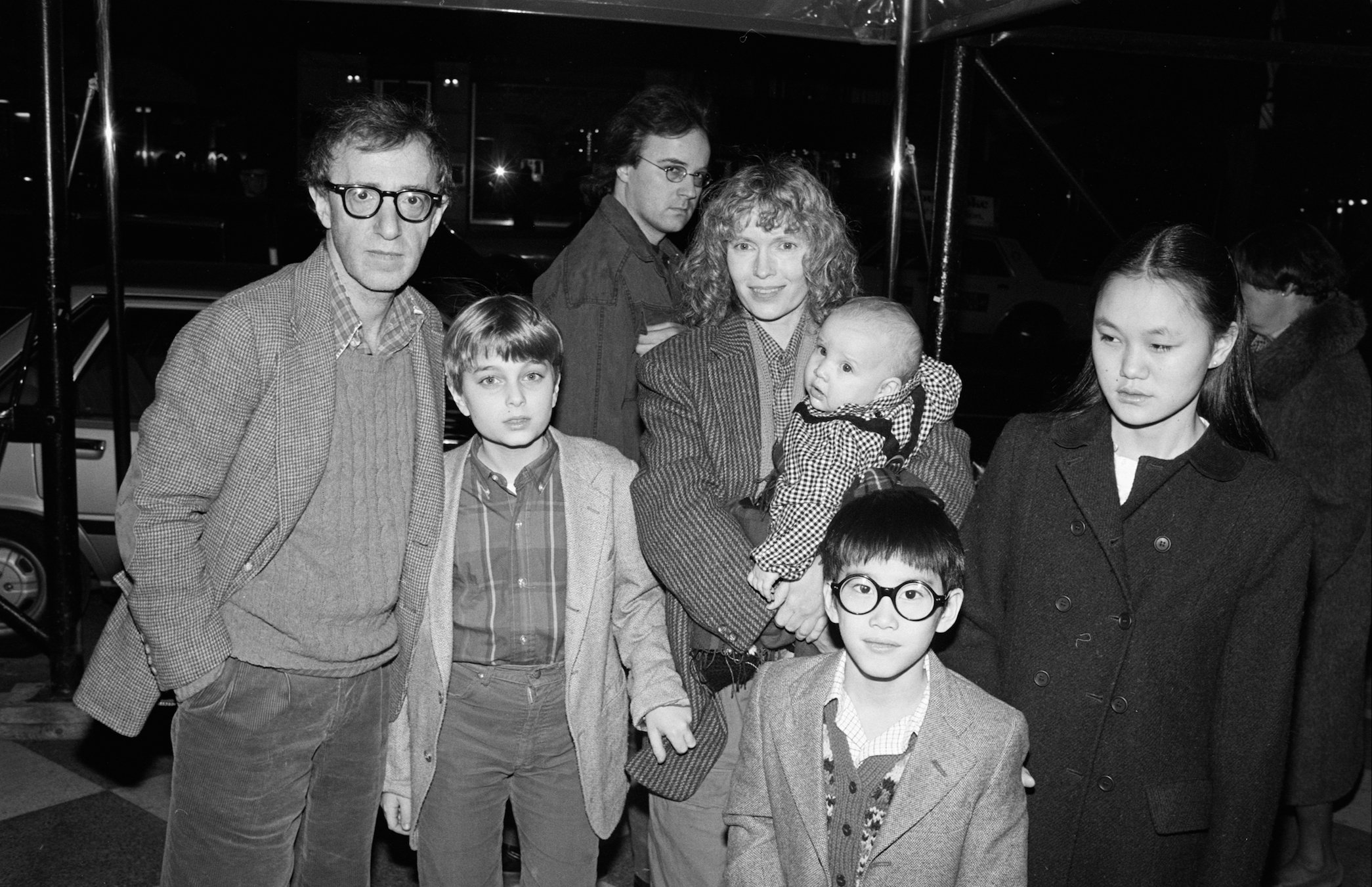 Woody Allen (left) and Mia Farrow pose under an awning with their children