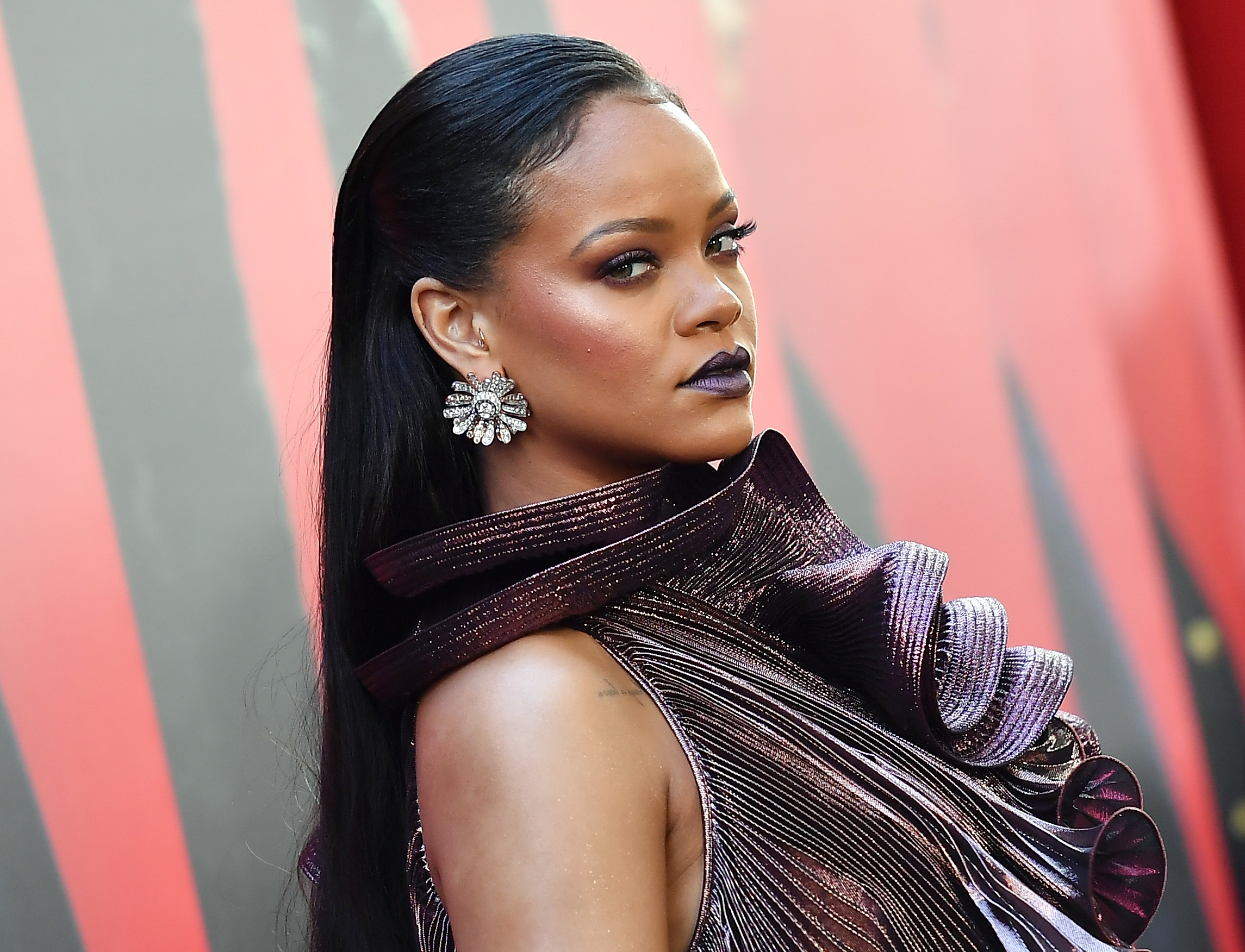 Rihanna with a red background