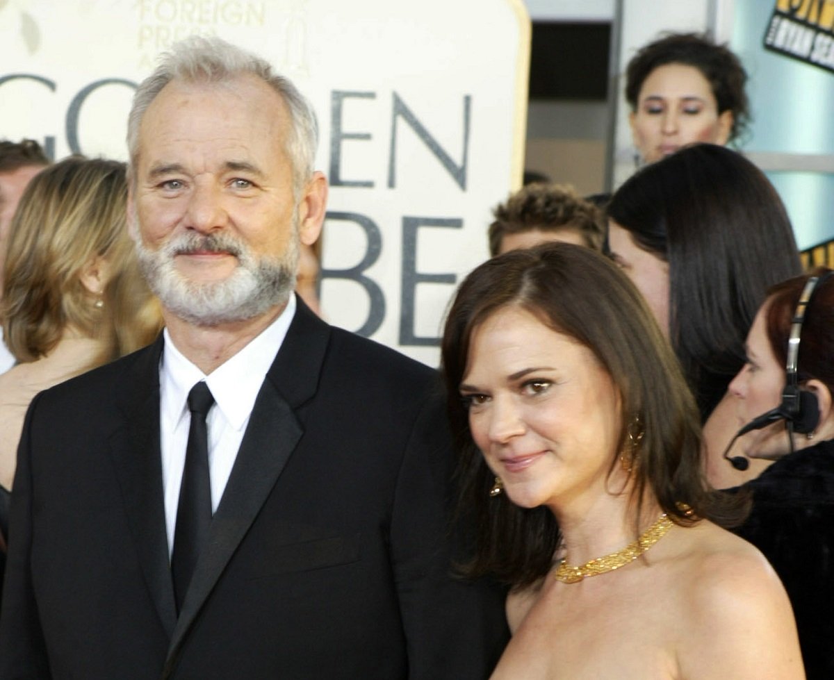 Bill Murray in a suit with his then-wife Jennifer Butler in front of a crowd