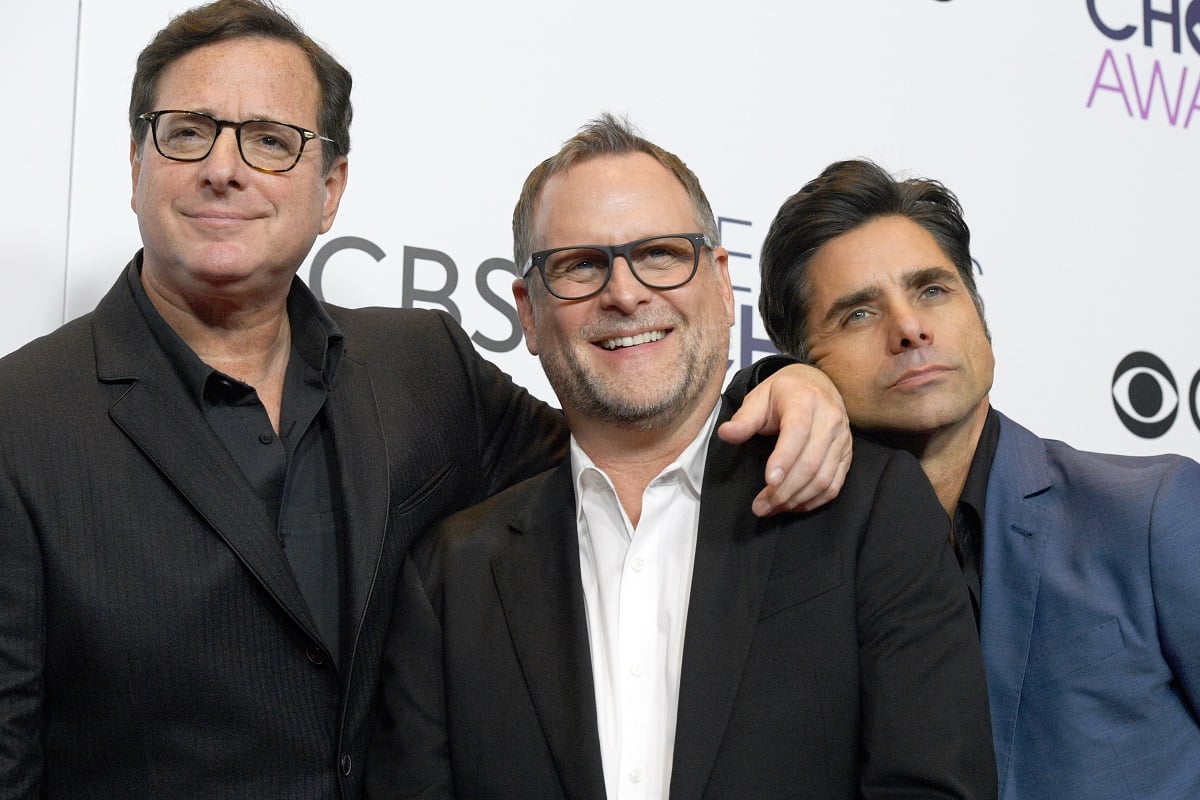 Bob Saget, Dave Coulier, and John Stamos pose with their arms around each other.