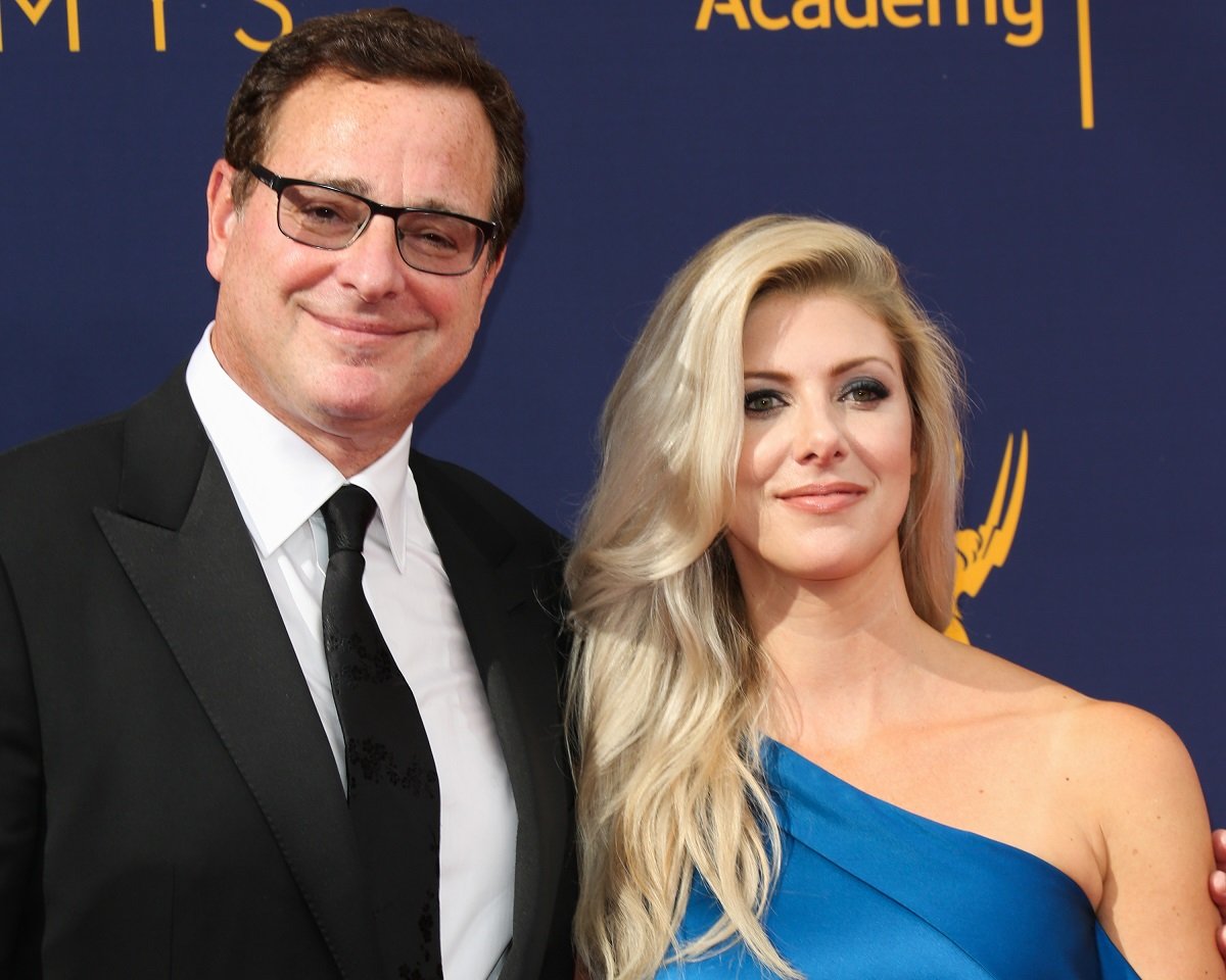 Bob Saget posing with his wife, Kelly Rizzo, in formal wear