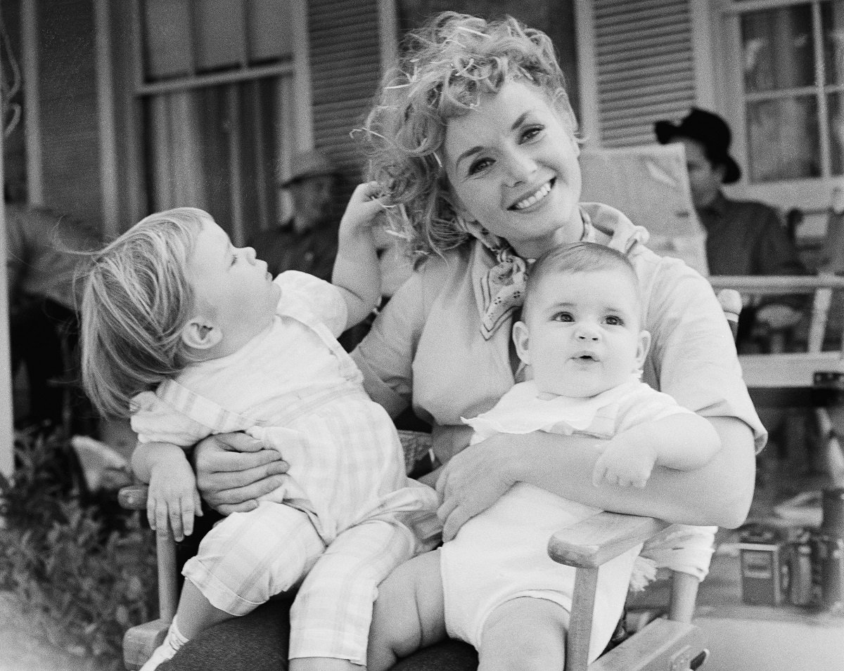 Debbie Reynolds holds her two children, Carrie and Todd, 8-mos, (right) in 1958.