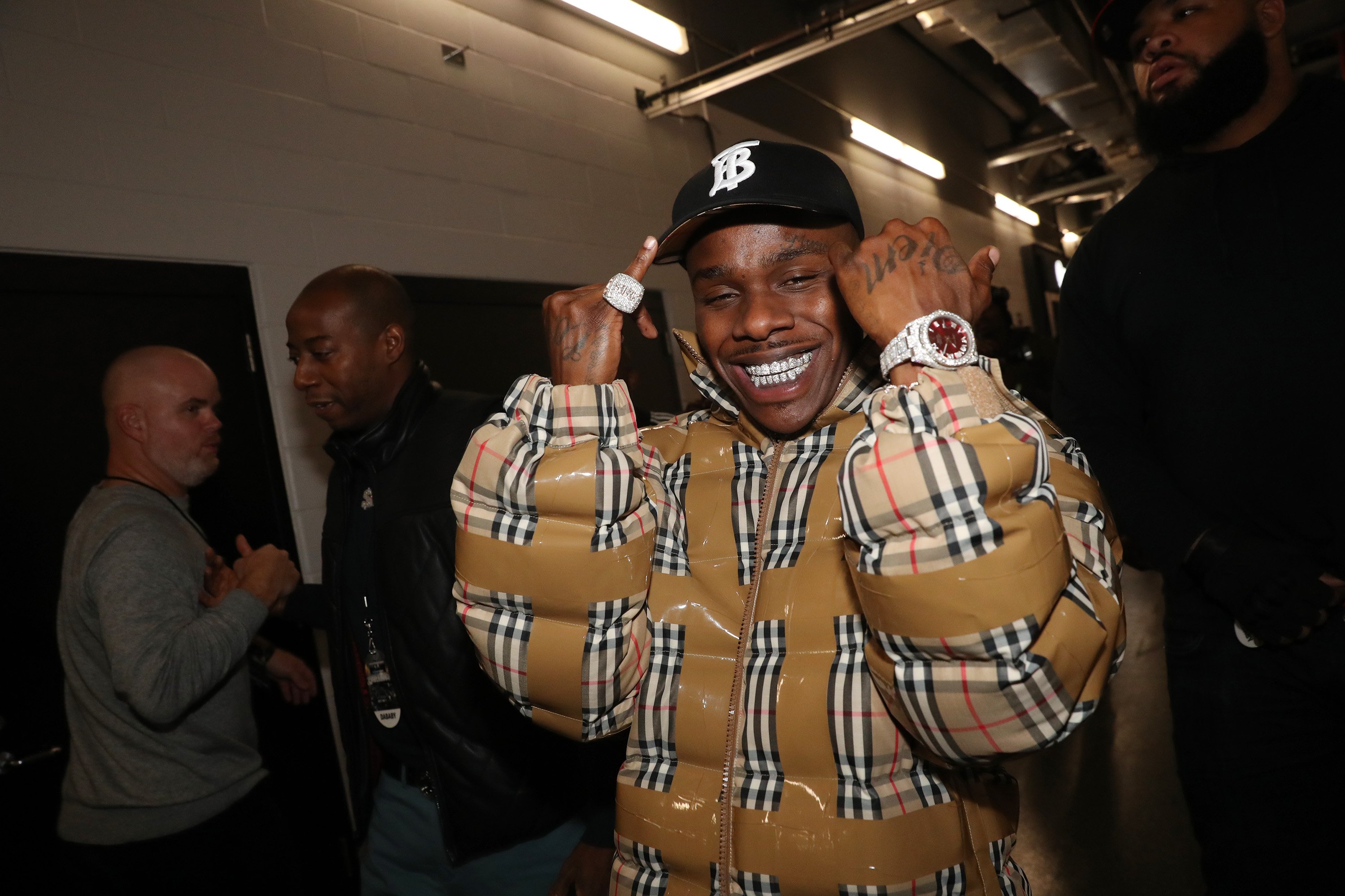 DaBaby backstage at a concert in a jackt