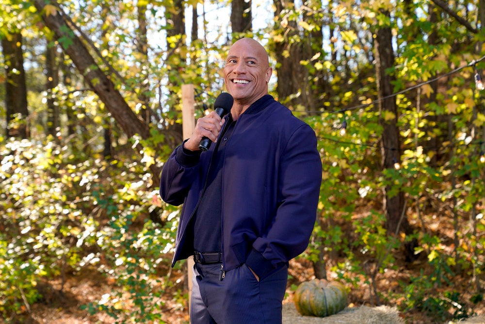 Dwayne the Rock Johnson holding a microphone
