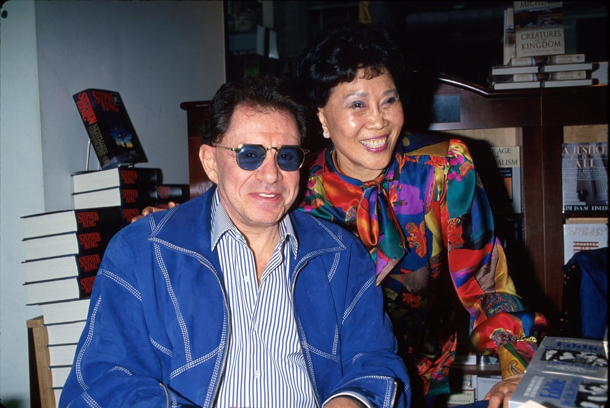 Eddie Fisher and wife Betty Lin signing his book.