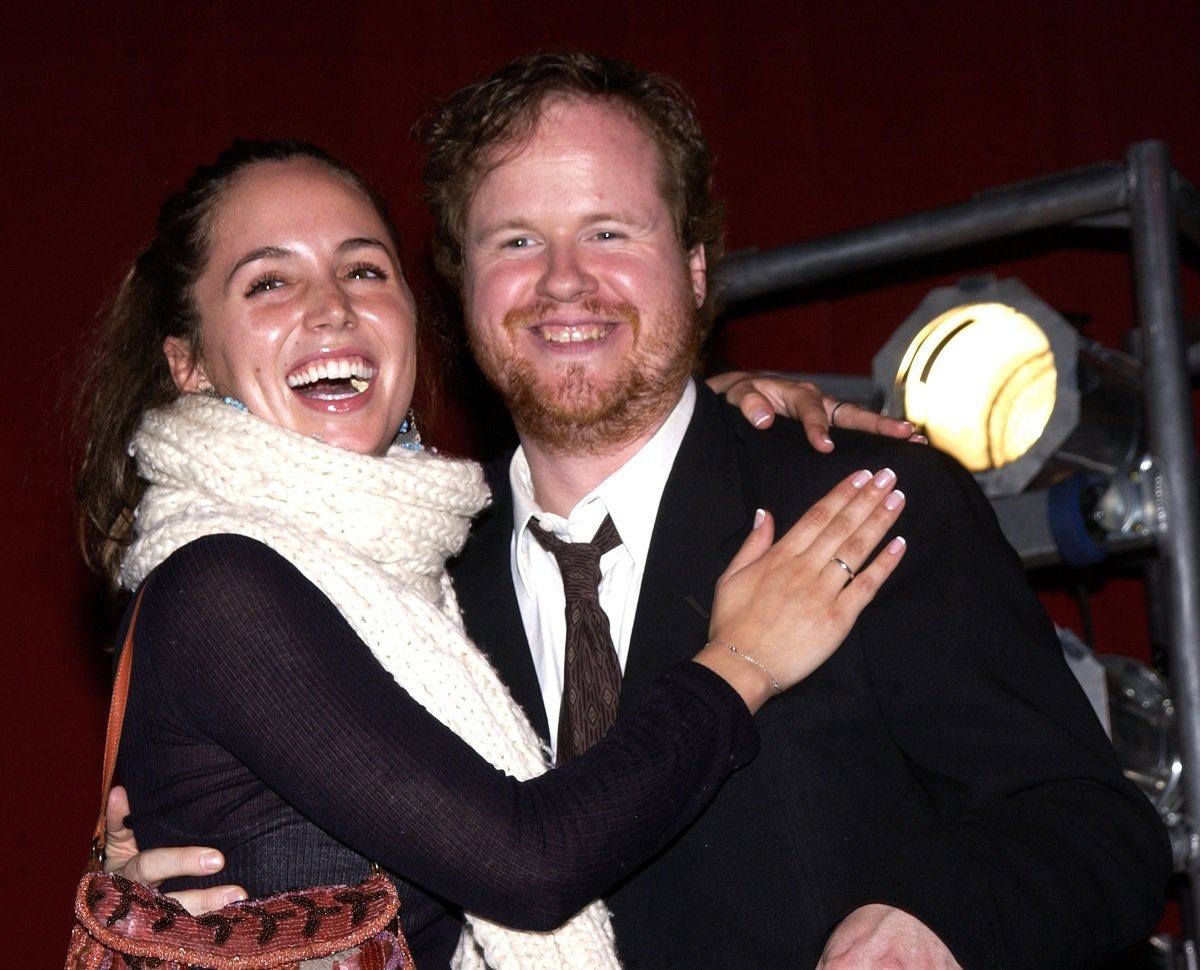 Eliza Dushku (L) laughing with her arms around a smiling Joss Whedon.