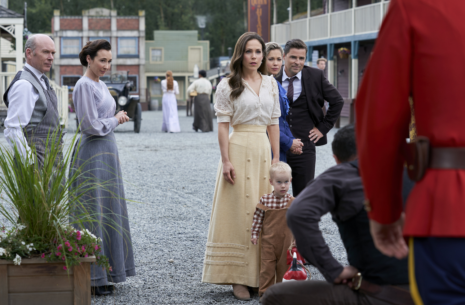 Elizabeth and her son Jack look at a crouching man in the When Calls the Heart Season 8 premeire