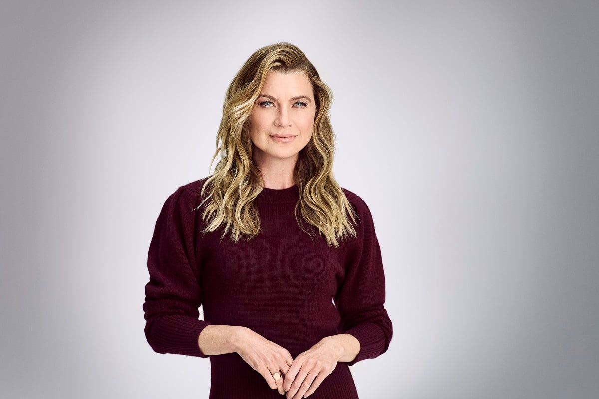 Ellen Pompeo in a maroon dress looking at the camera