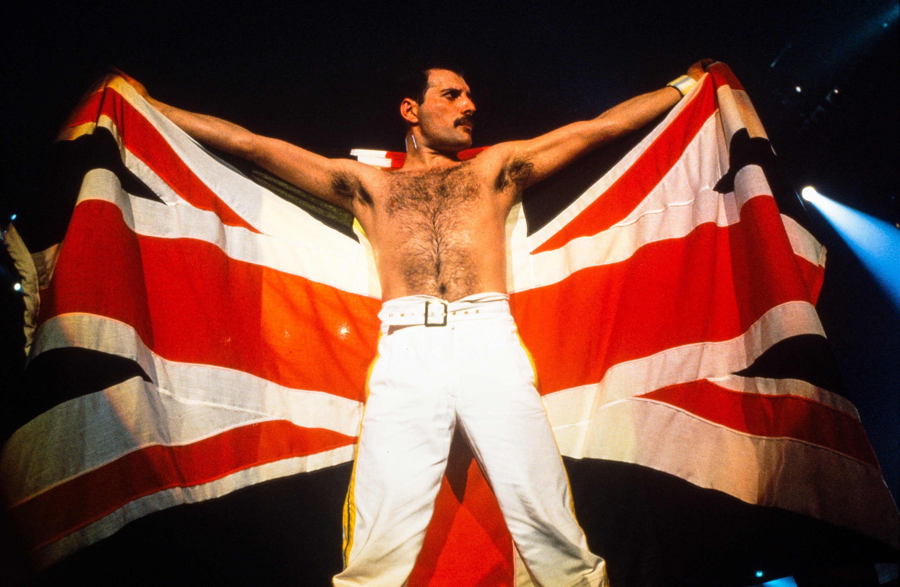 Freddie Mercury holding a flag