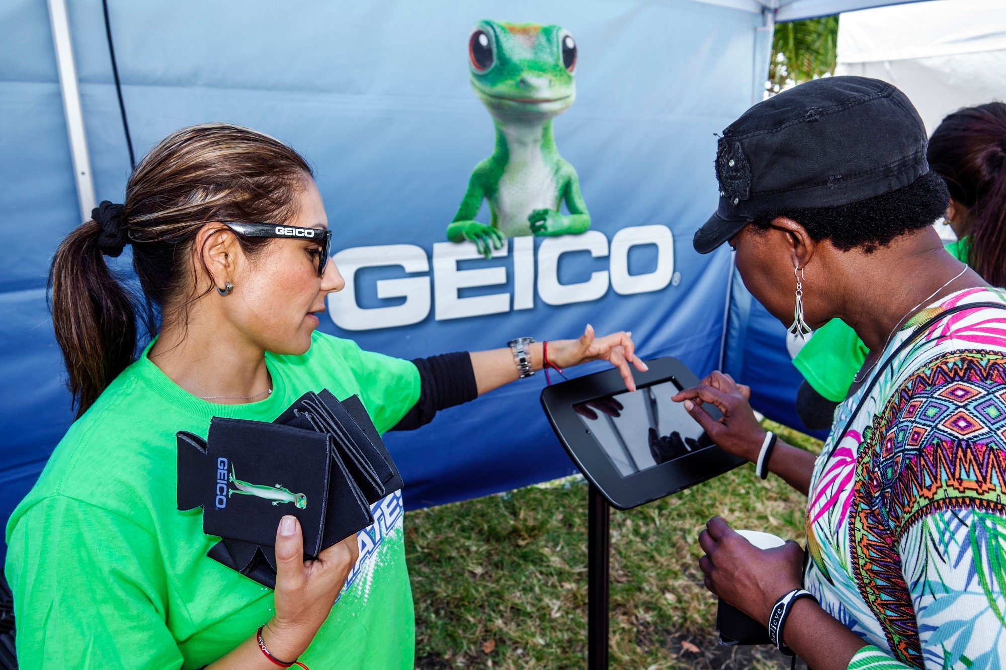 Florida, Miami Beach Art Deco Weekend Street Fair, the GEICO lizard looks on from the GEICO Insurance Survey Kiosk