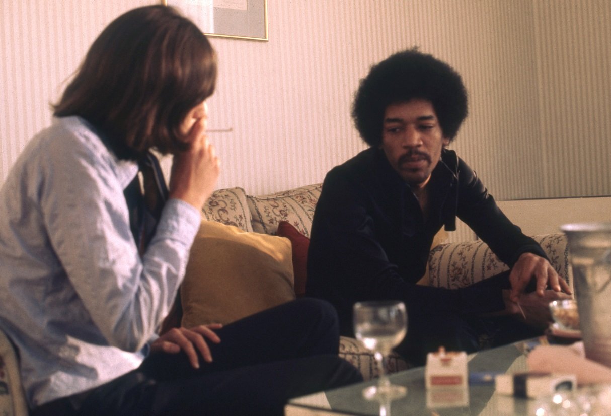 Jimi Hendrix sitting with Jann Wenner in a hotel room