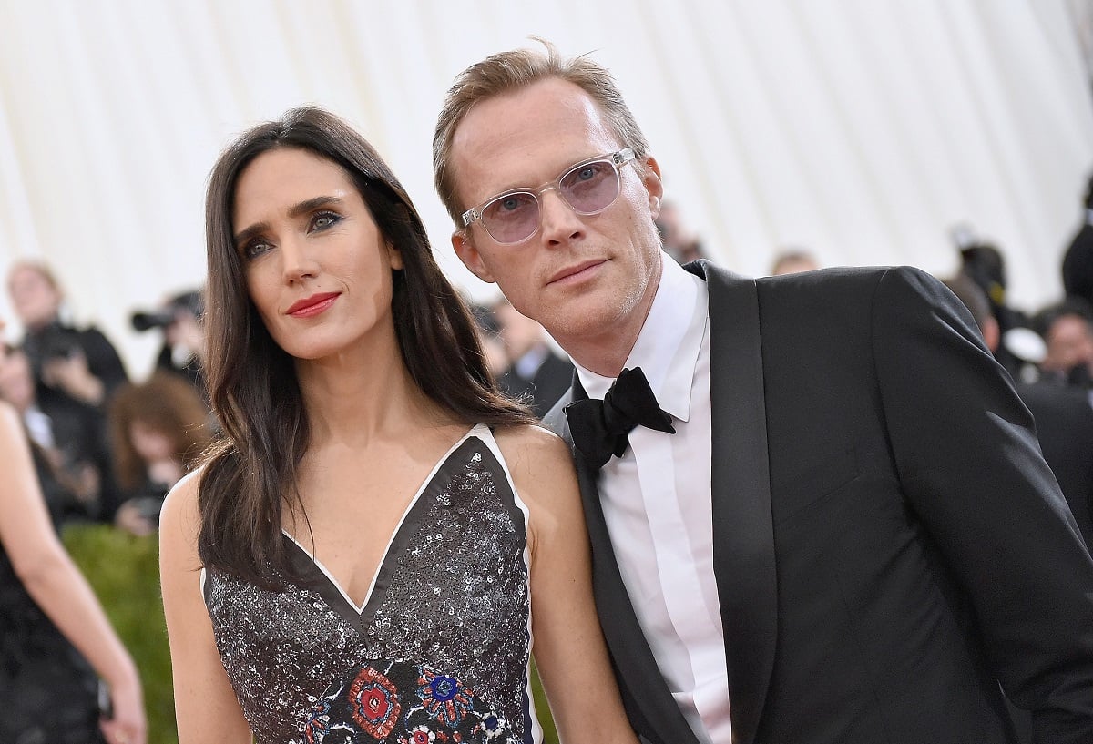Jennifer Connelly (L) and Paul Bettany pose outside in front of photographers