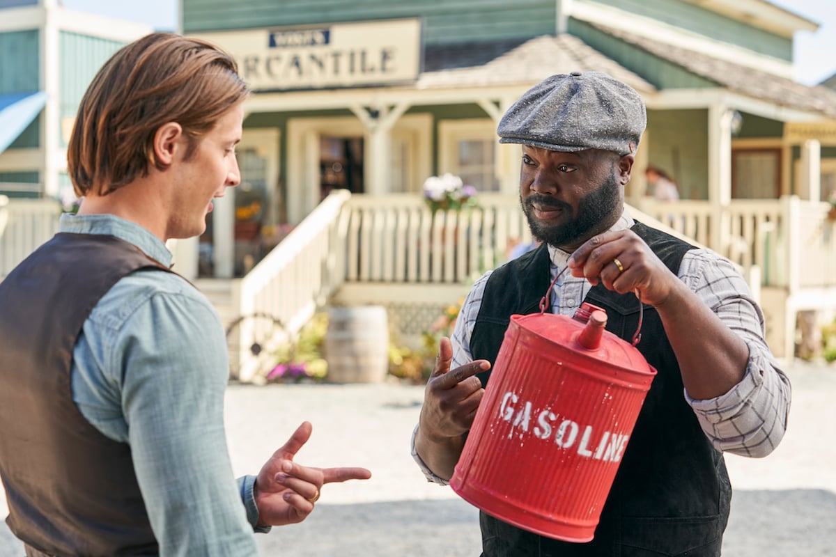 Jesse talks to Joseph, who is holding a gas can, in an episode of When Calls the Heart