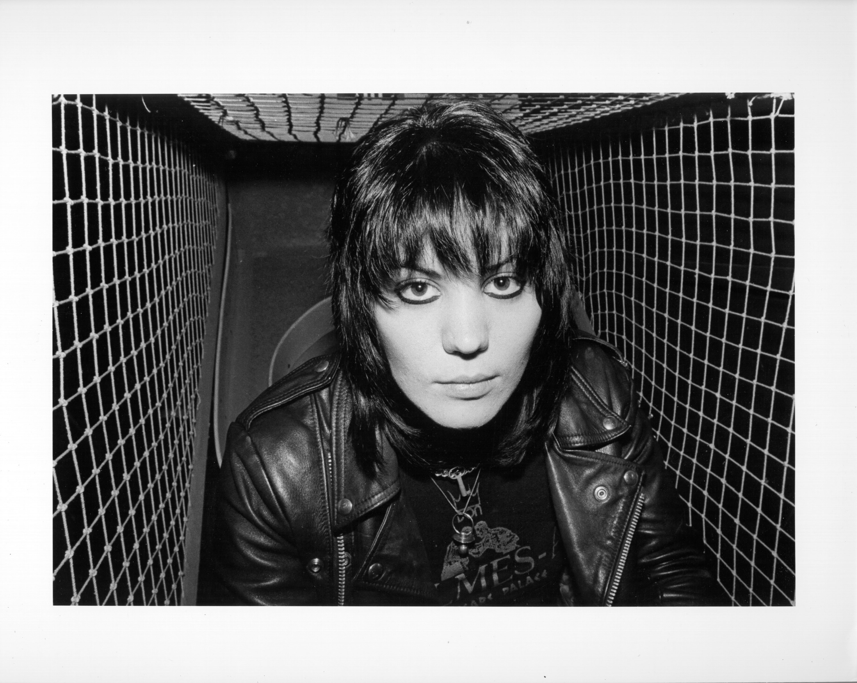 Joan Jett in front of a black wall