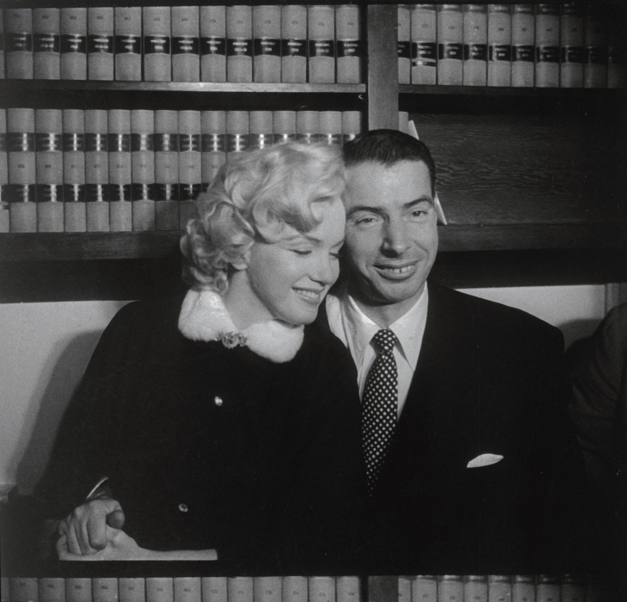 Marilyn Monroe and Joe DiMaggio Sitting Close Together