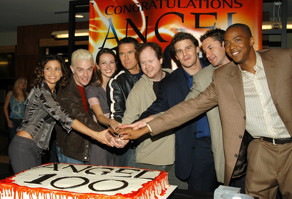 Joss Whedon, creator and executive producer of 'Angel' and cast cut a cake.