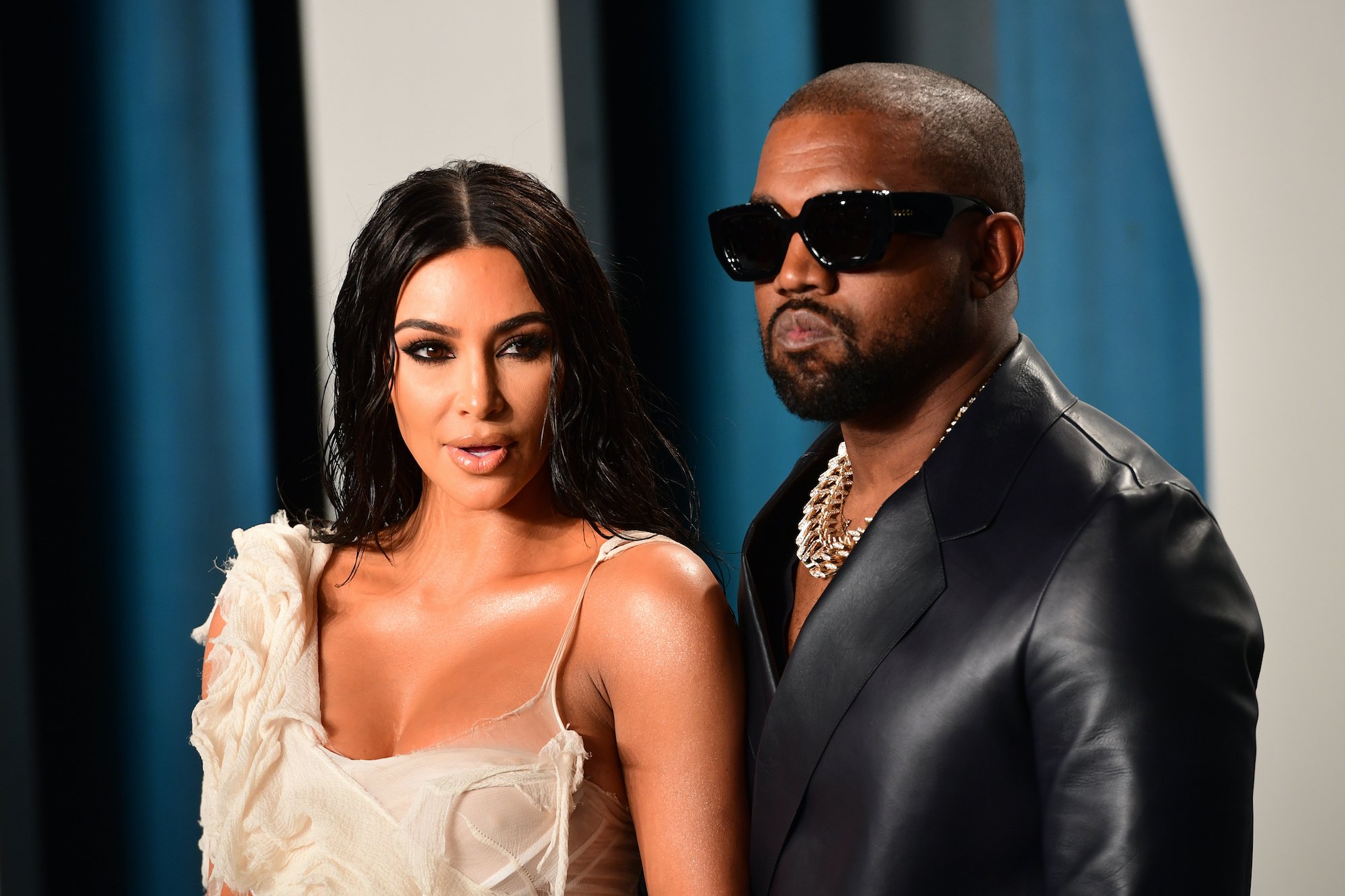 Kim Kardashian and Kanye West stand together on the red carpet at an award show.