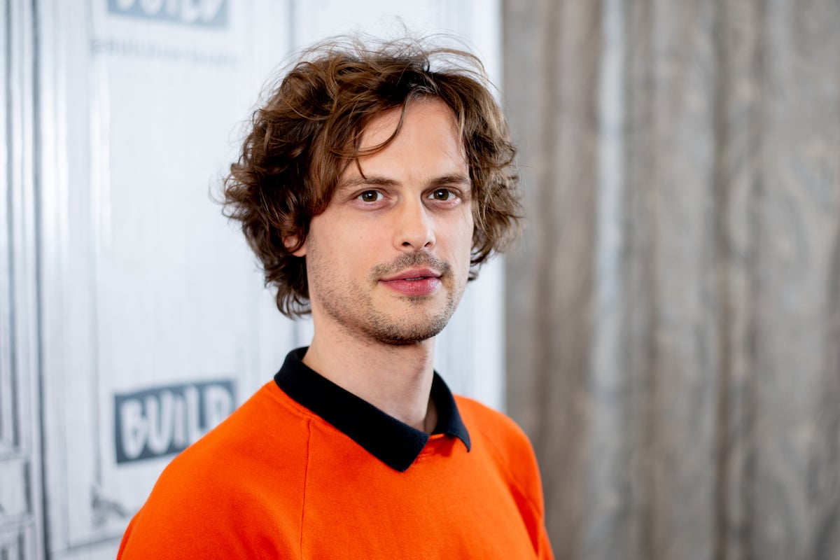 Matthew Gray Gubler wearing an orange shirt