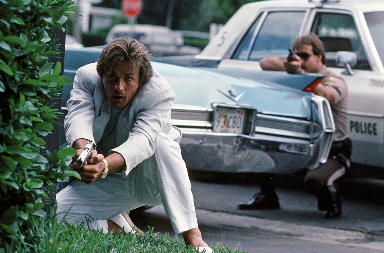 Don Johnson holding a gun in a scene from 'Miami Vice'