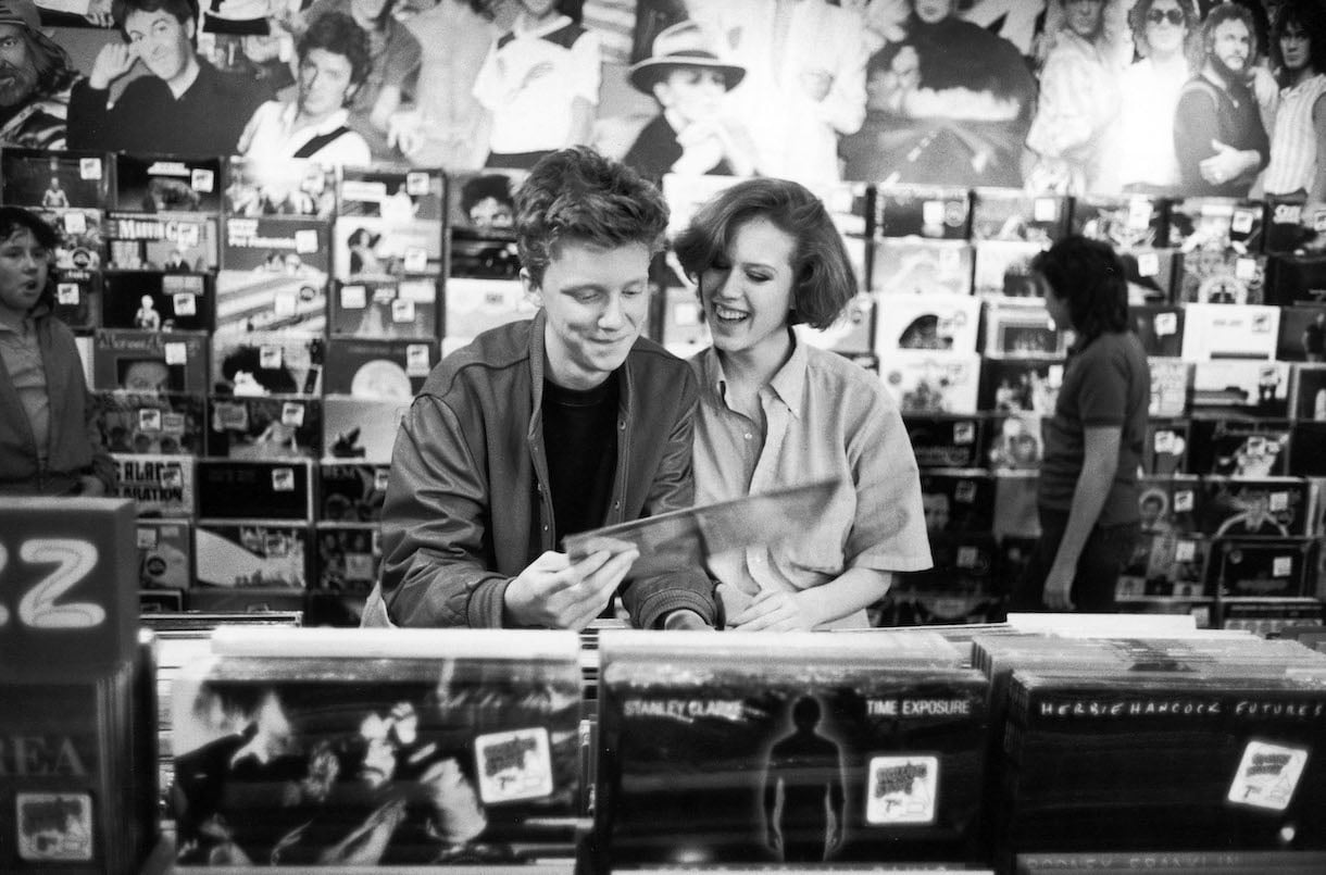 Actors Anthony Michael Hall and Molly Ringwald browsing in record shop during break in location shooting of 'The Breakfast Club'