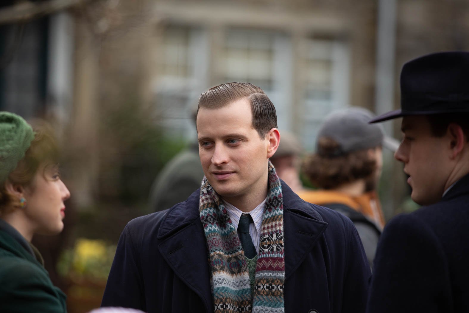 Nicholas Ralph as James Herriot wearing a scarf in All Creatures Great and Small