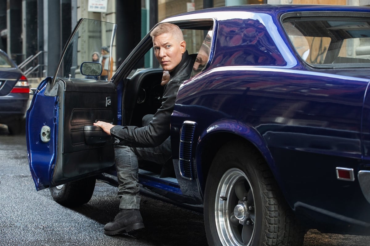 Joseph Sikora as Tommy Egan in 'Power' sitting in his car with the door open looking behind him