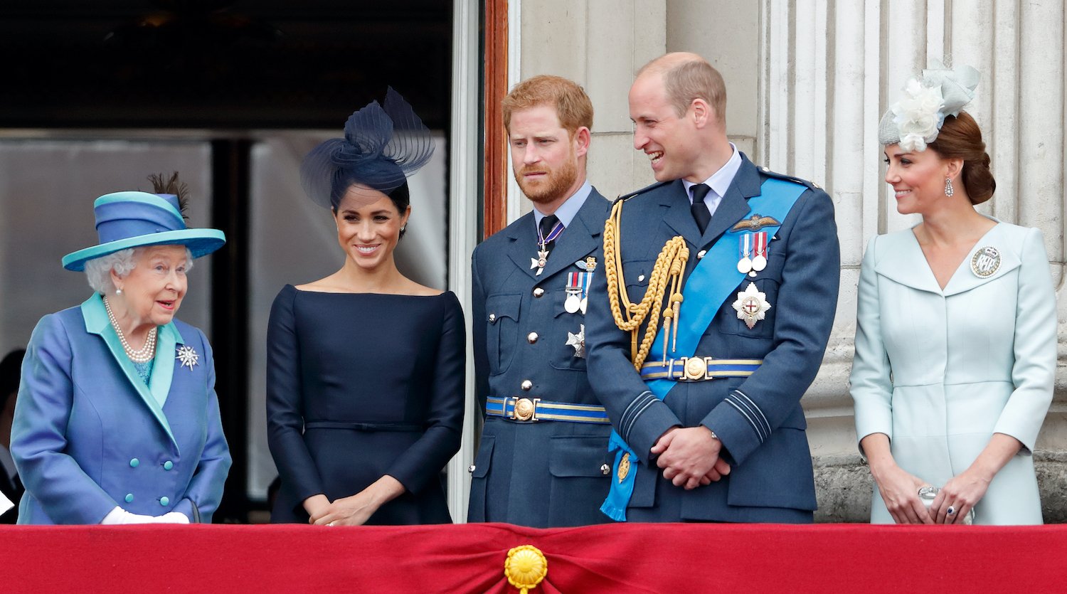 Queen Elizabeth II, Meghan Markle, Prince Harry, Prince William, and Kate Middleton watch a flypast to mark the centenary of the Royal Air Force from the balcony of Buckingham Palace on July 10, 2018