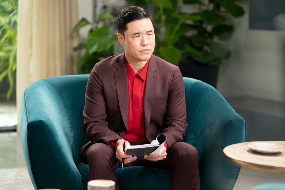 Randall Park seated in a chaiir