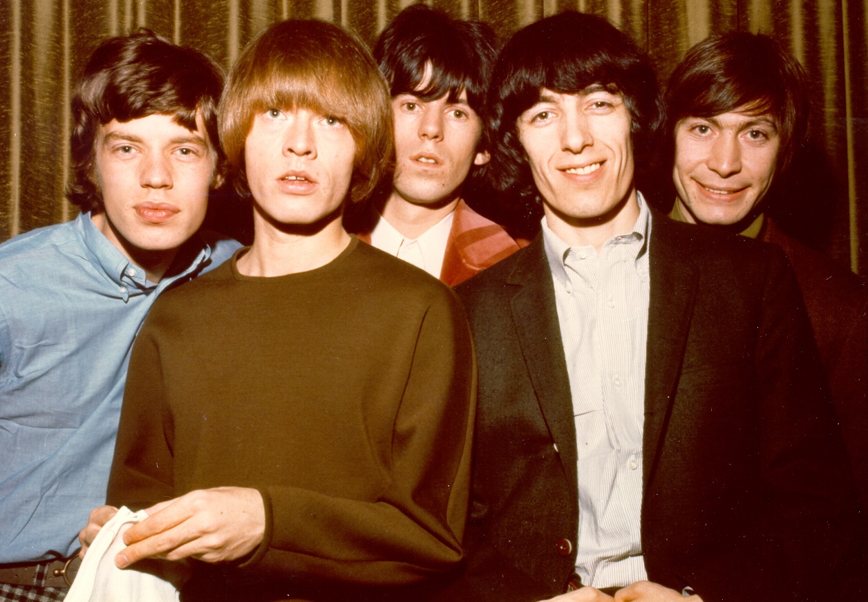 The Rolling Stones smile for the camera in a 1964 band photo