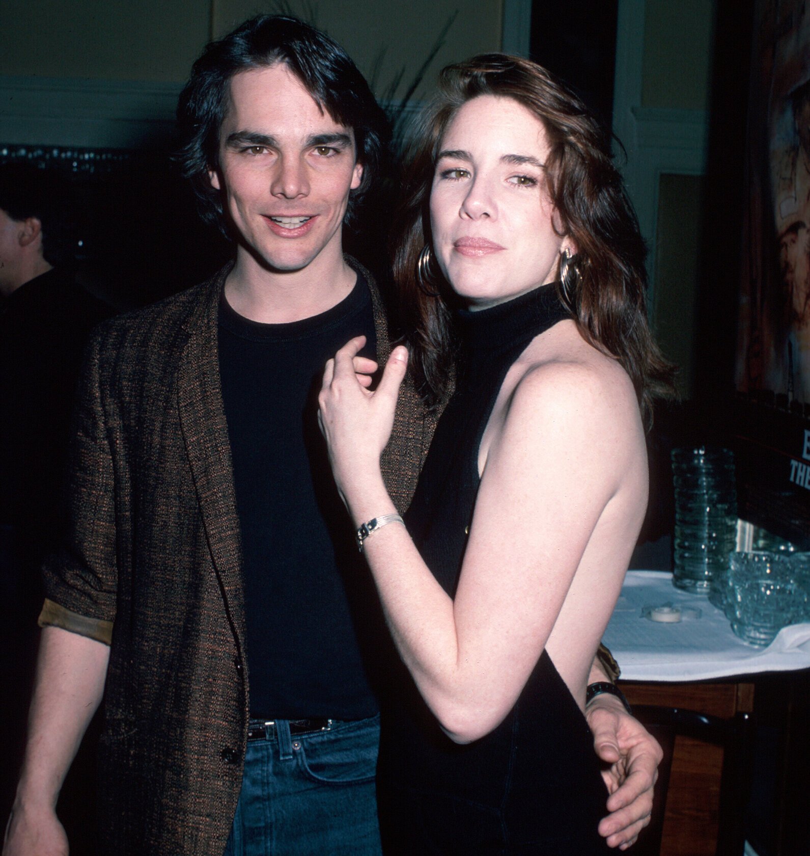 Bo Brinkman has his arm around Melissa Gilbert, who's in a black backless dress.