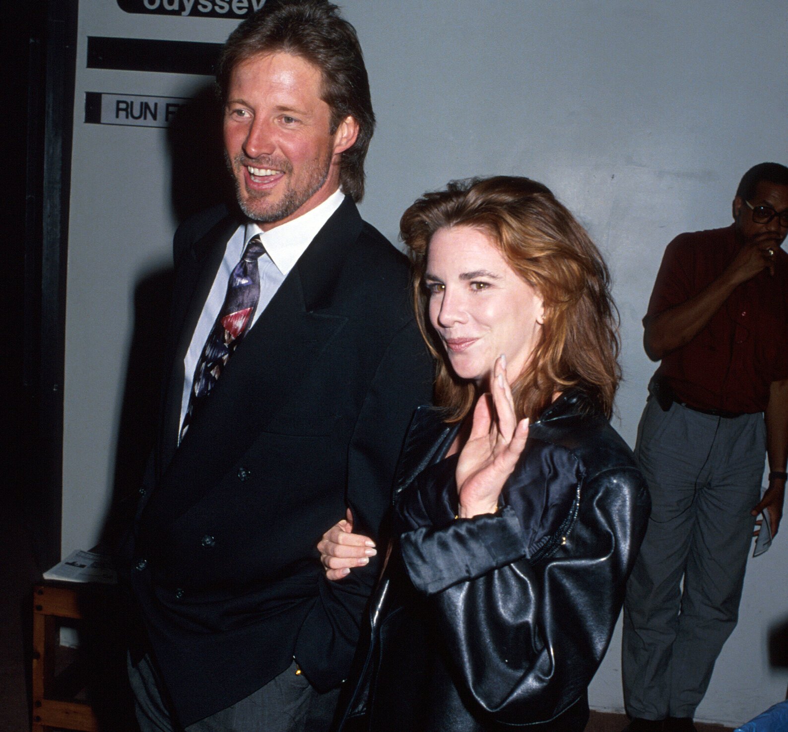 Bruce Boxleitner and Melissa Gilbert — Gilbert is holding Boxleitner's arm, smiling and waving.
