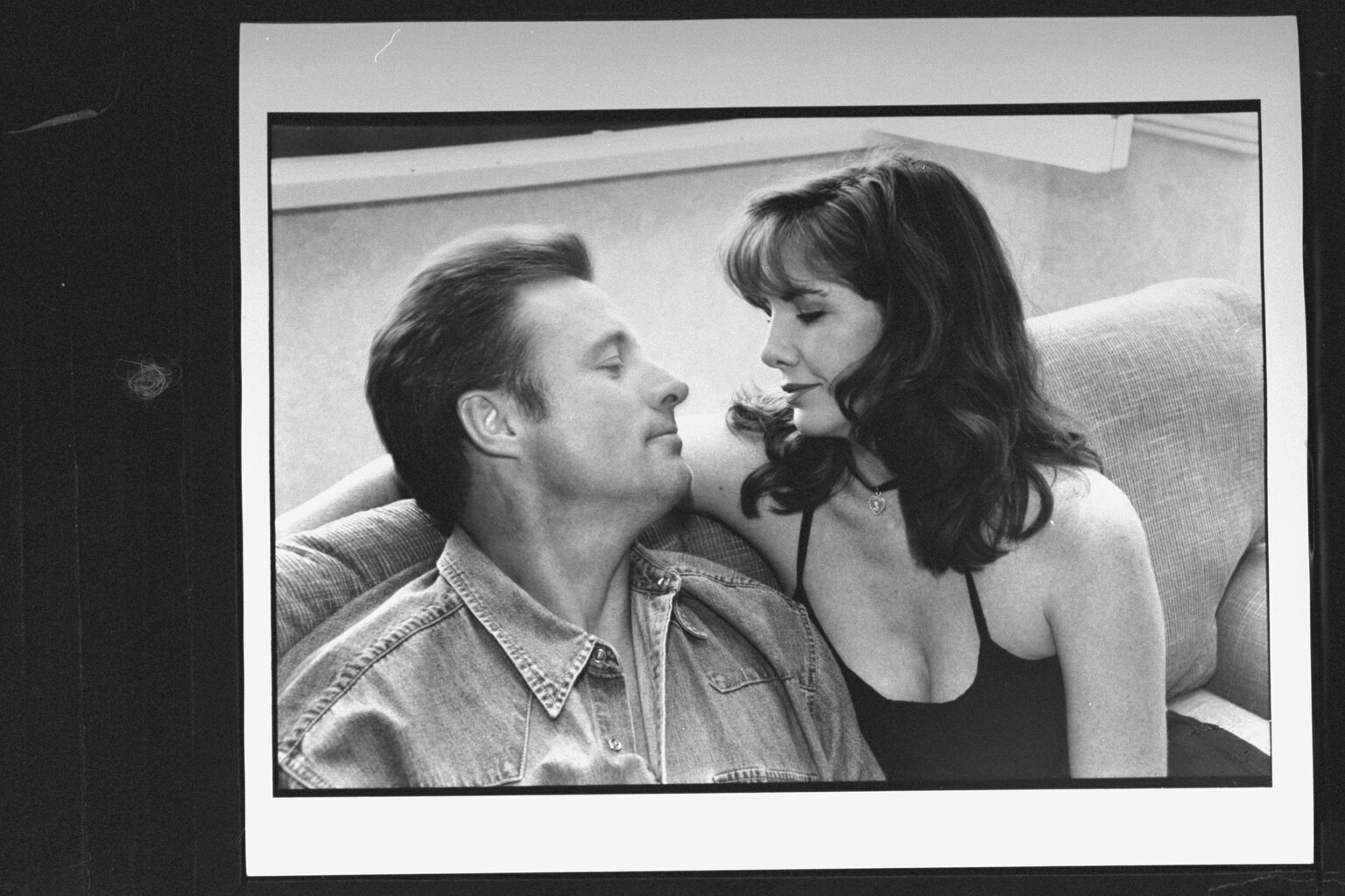Melissa Gilbert lovingly gazing into the eyes of her actor fiance Bruce Boxleitner as they cuddle on sofa in their hotel room